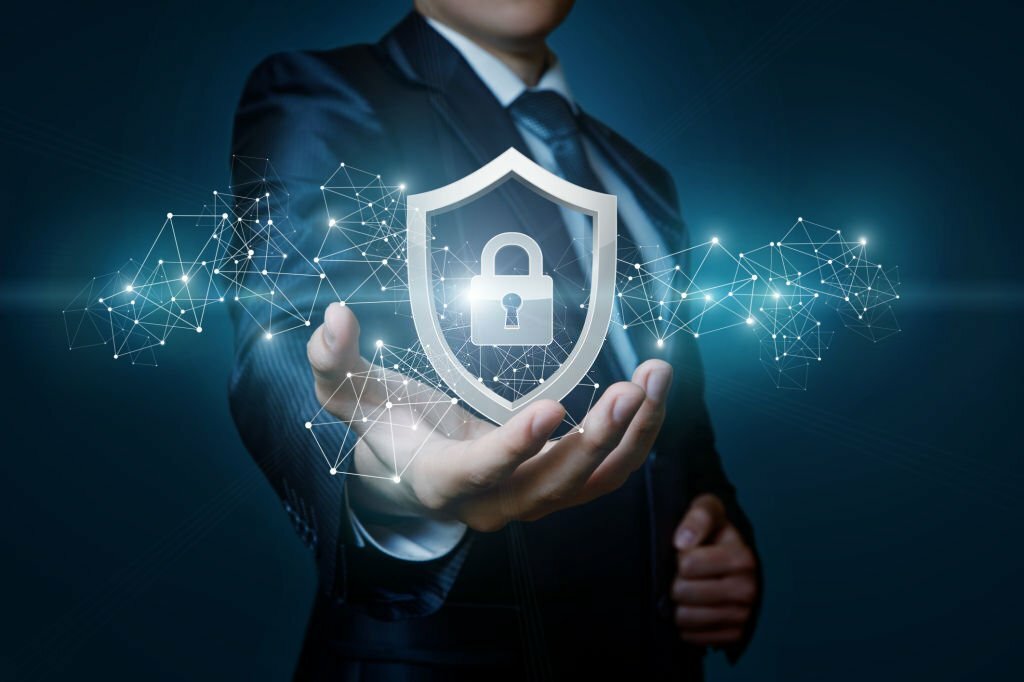 Protection network security computer in the hands of a businessman on a blue background.